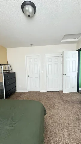 a bedroom with a bed and a chandelier