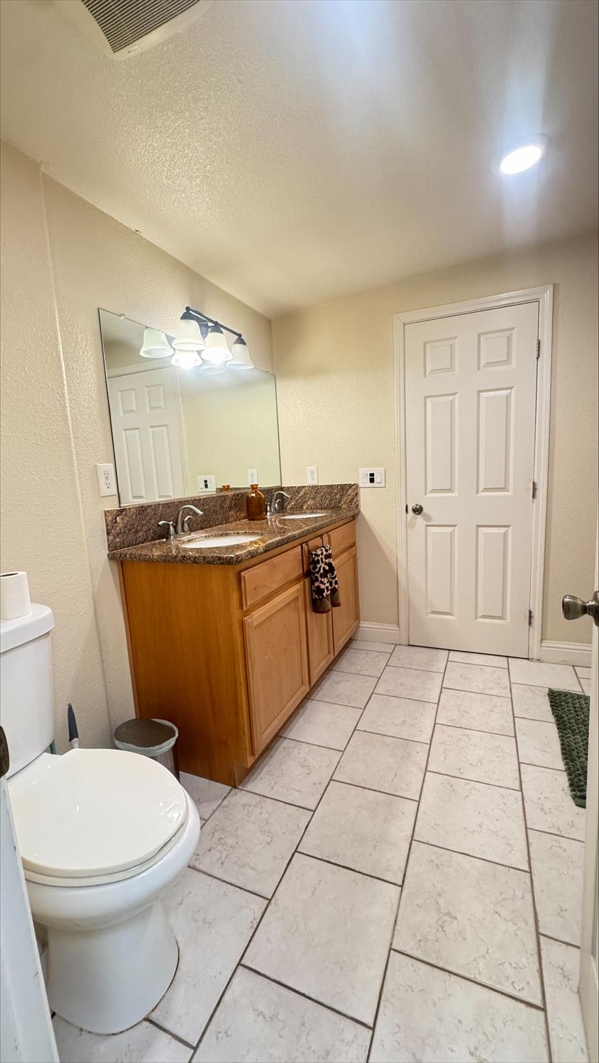 410 Sage Street Gridley, CA 95948 - Photo 19 of 43 a bathroom with a sink a toilet and a mirror
