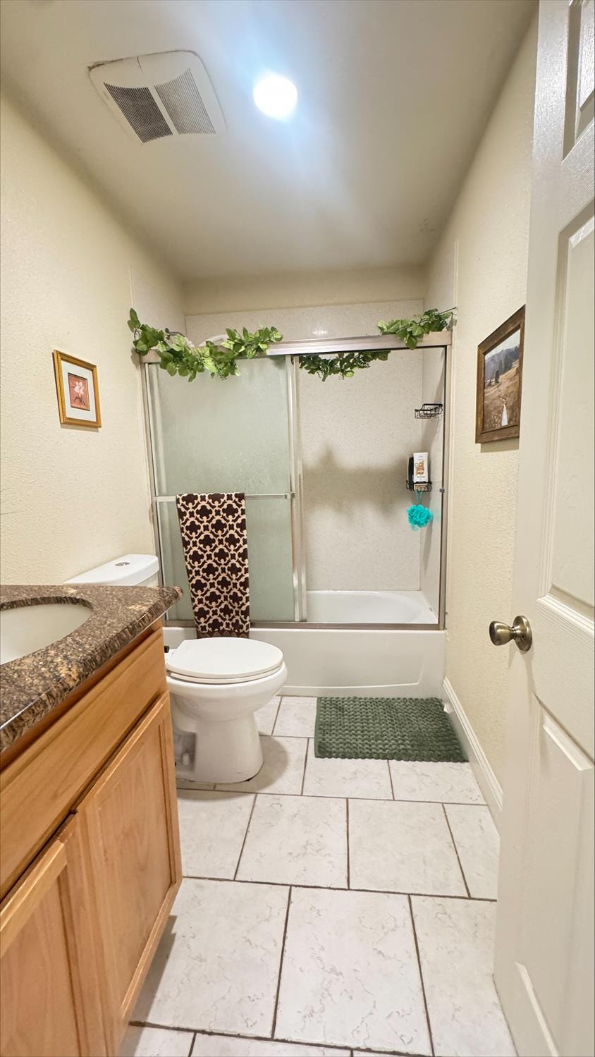 410 Sage Street Gridley, CA 95948 - Photo 29 of 43 a bathroom with a granite countertop sink toilet and shower