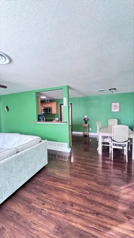 a bedroom with a bed and a view of kitchen