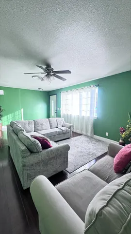 a spacious bathroom with a granite countertop sink and a mirror