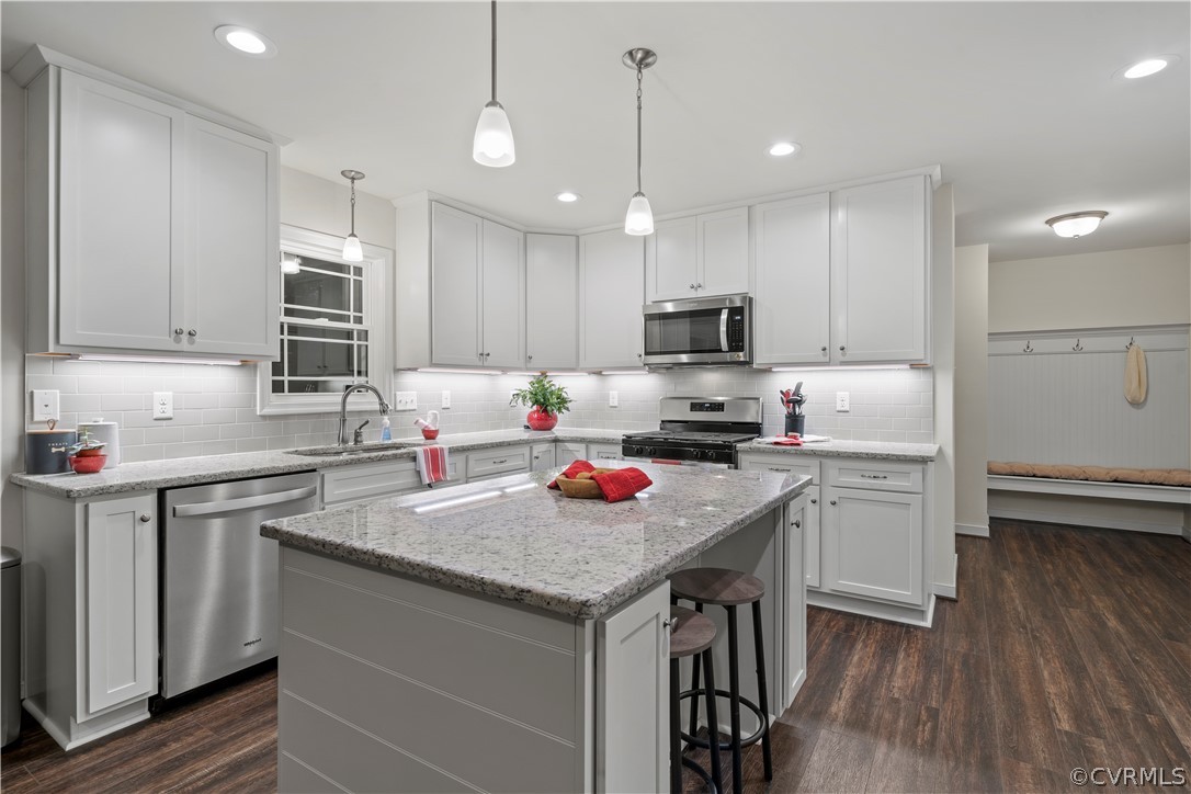 2829 Preston Park Way Sandy Hook, VA 23153 - Photo 12 of 36 a kitchen with stainless steel appliances granite countertop a stove refrigerator a sink a stove and cabinets