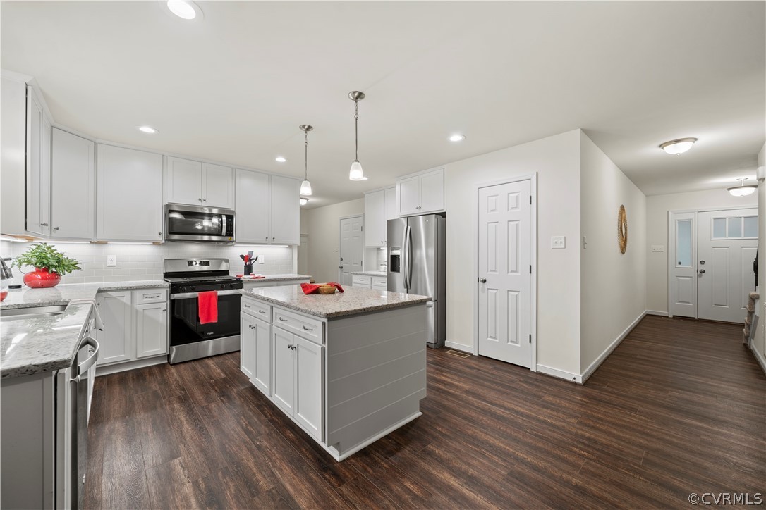 2829 Preston Park Way Sandy Hook, VA 23153 - Photo 13 of 36 a kitchen with stainless steel appliances granite countertop a stove and a refrigerator