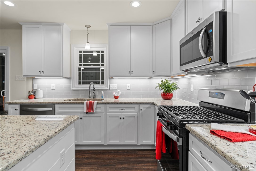 2829 Preston Park Way Sandy Hook, VA 23153 - Photo 16 of 36 a kitchen with stainless steel appliances granite countertop a sink stove and cabinets