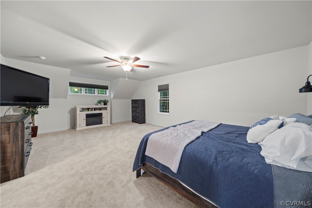 2829 Preston Park Way Sandy Hook, VA 23153 - Photo 18 of 36 a spacious bedroom with a bed and a flat screen tv