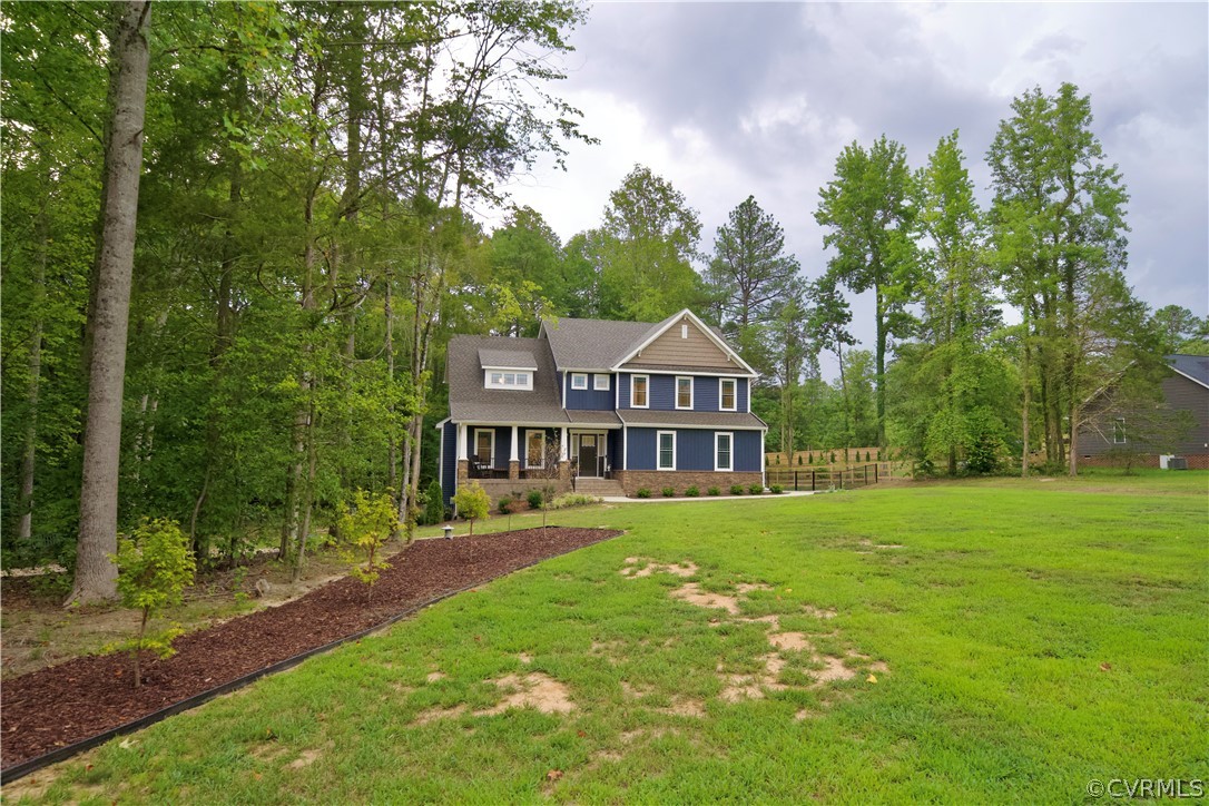 2829 Preston Park Way Sandy Hook, VA 23153 - Photo 2 of 36 a front view of a house with garden