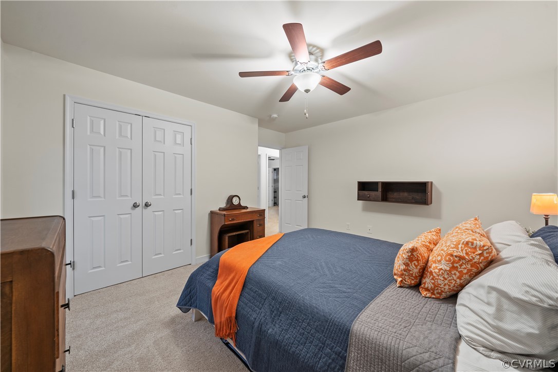 2829 Preston Park Way Sandy Hook, VA 23153 - Photo 31 of 36 a bedroom with two beds and a chandelier