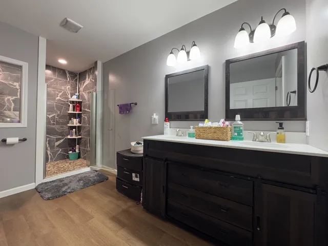 a bathroom with a double vanity sink and a mirror
