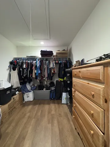 a living room with lots of furniture and clutter