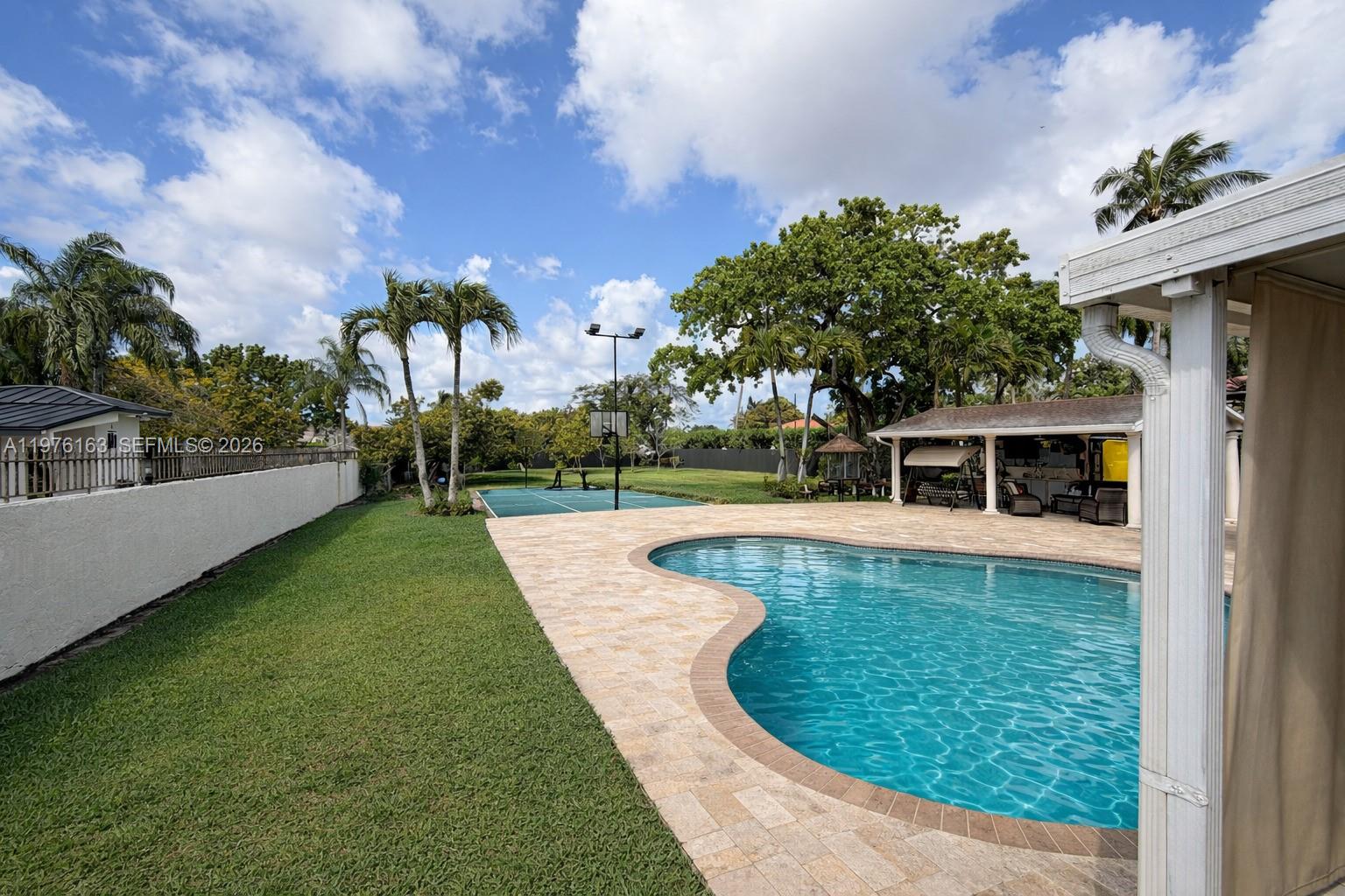 3500 Southwest 128th Avenue Miami, FL 33175 - Photo 11 of 27 a view of a swimming pool with a yard