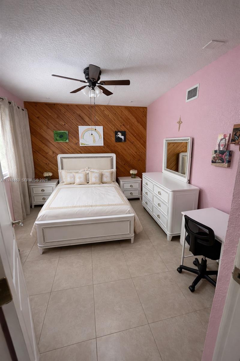 3500 Southwest 128th Avenue Miami, FL 33175 - Photo 12 of 27 a bedroom with a bed and a chair