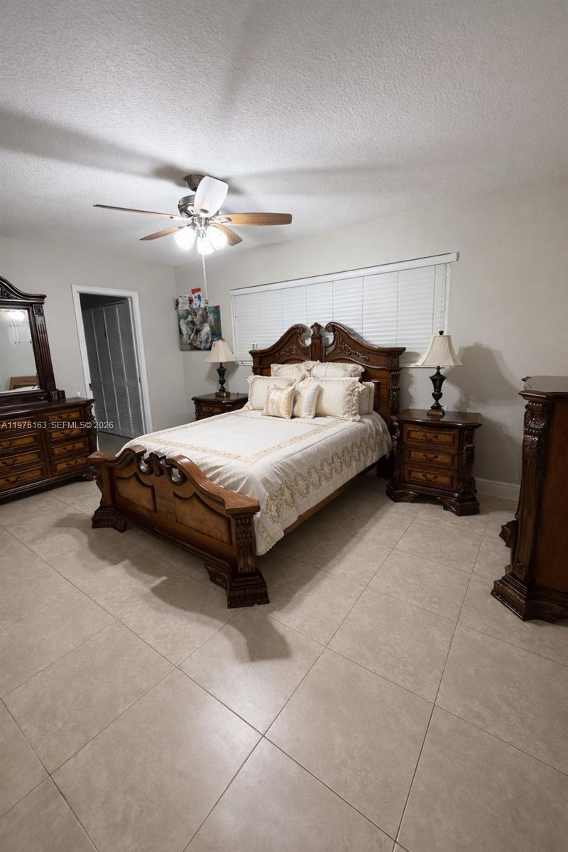 3500 Southwest 128th Avenue Miami, FL 33175 - Photo 13 of 27 a bedroom with a bed and a chandelier