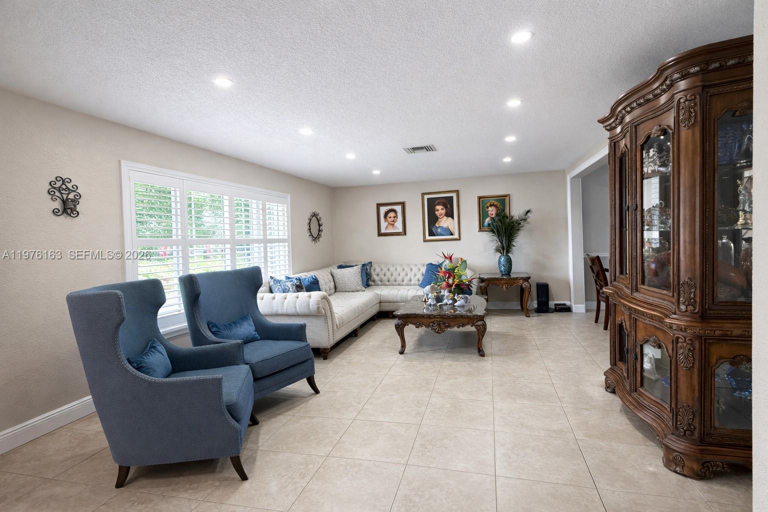 3500 Southwest 128th Avenue Miami, FL 33175 - Photo 14 of 27 a living room with furniture and a flat screen tv