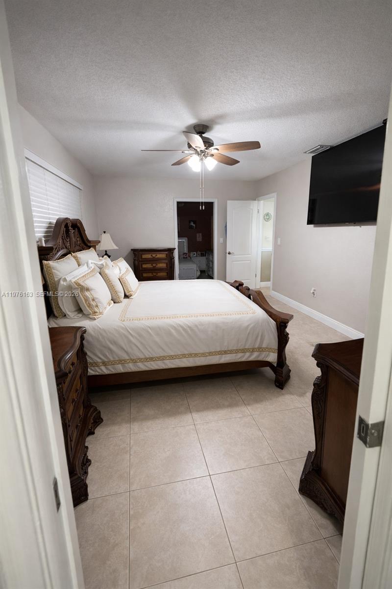 3500 Southwest 128th Avenue Miami, FL 33175 - Photo 15 of 27 a bedroom with a bed and a flat screen tv