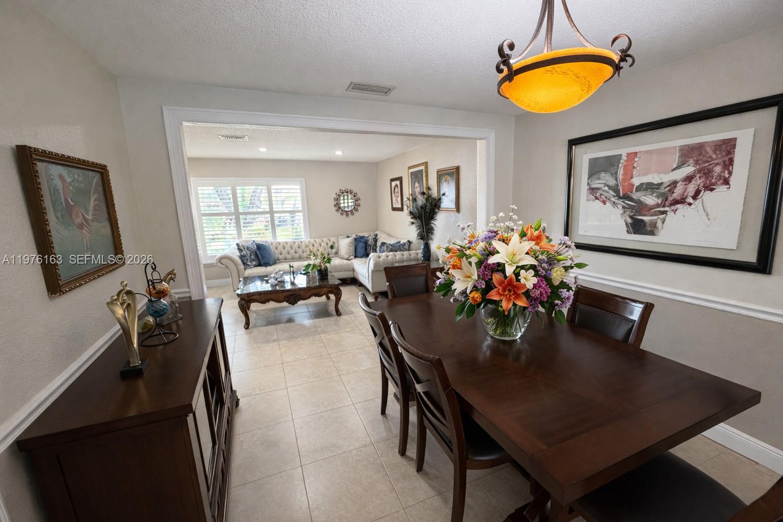3500 Southwest 128th Avenue Miami, FL 33175 - Photo 18 of 27 a view of a dining room with furniture and chandelier