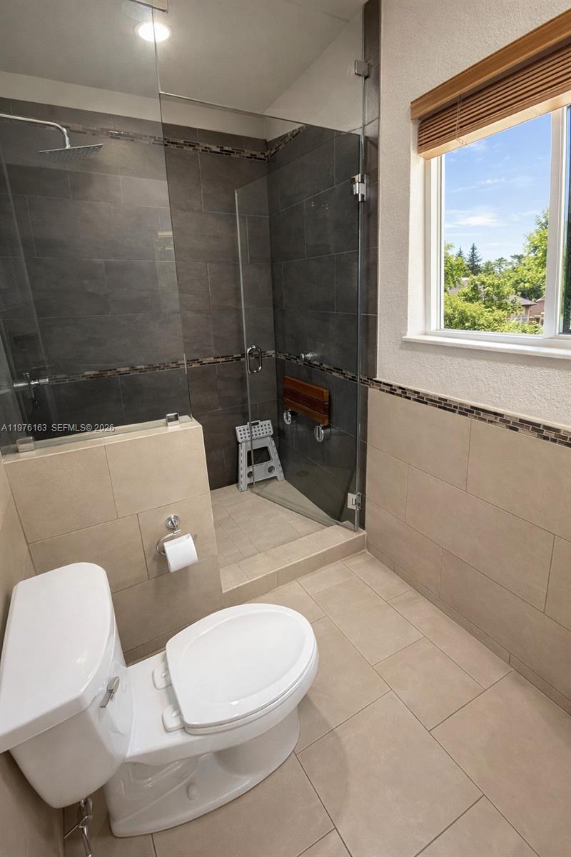 3500 Southwest 128th Avenue Miami, FL 33175 - Photo 23 of 27 a white toilet sitting next to a bathroom sink and a shower