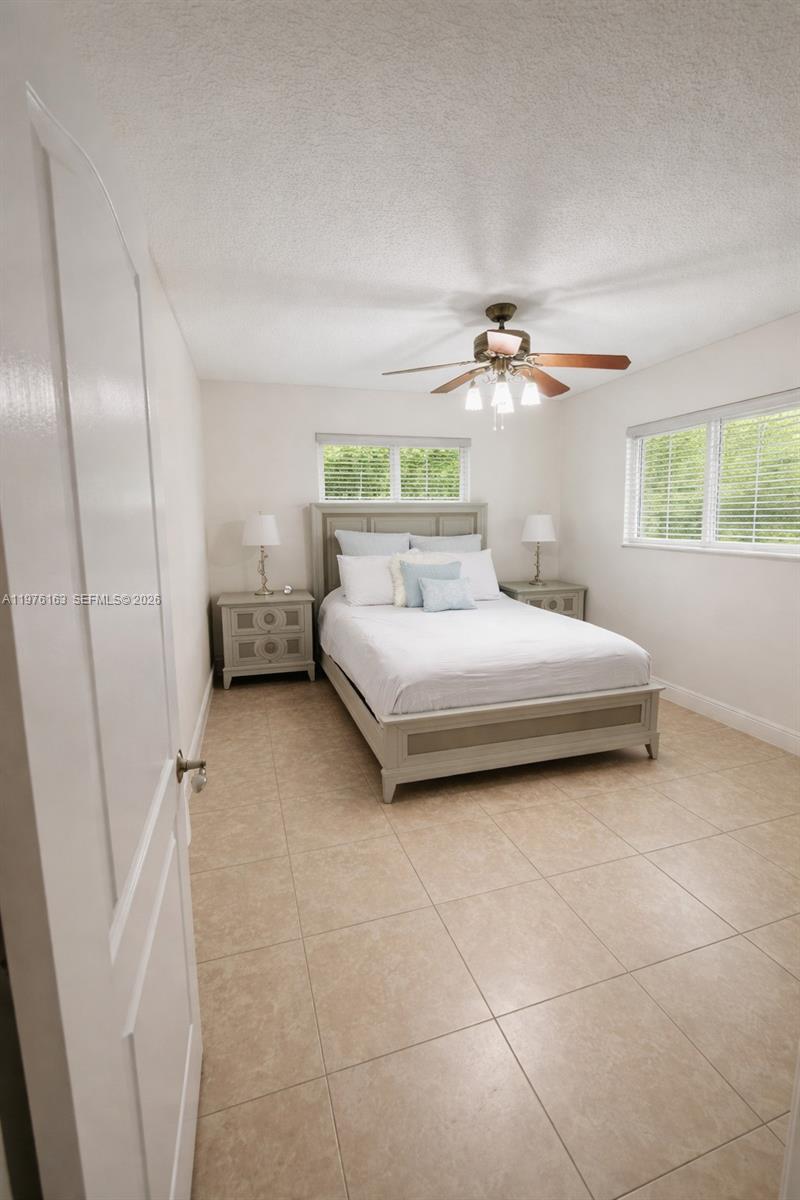 3500 Southwest 128th Avenue Miami, FL 33175 - Photo 24 of 27 a bedroom with a bed and a chandelier