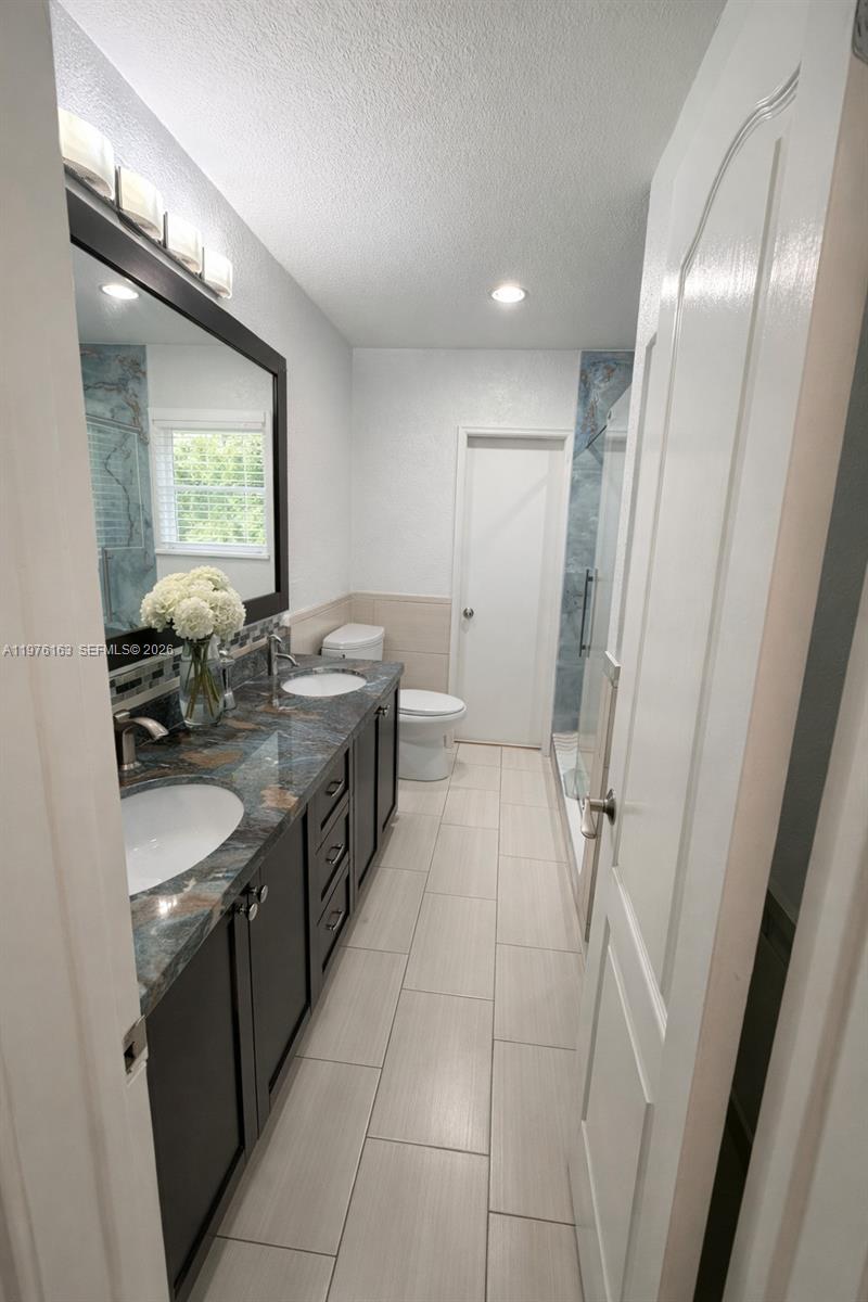 3500 Southwest 128th Avenue Miami, FL 33175 - Photo 25 of 27 a bathroom with double vanity and a mirror