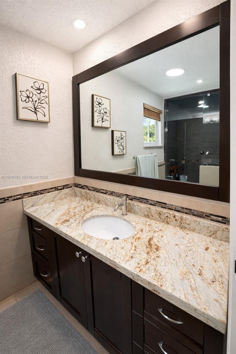 3500 Southwest 128th Avenue Miami, FL 33175 - Photo 26 of 27 a bathroom with a sink and a mirror
