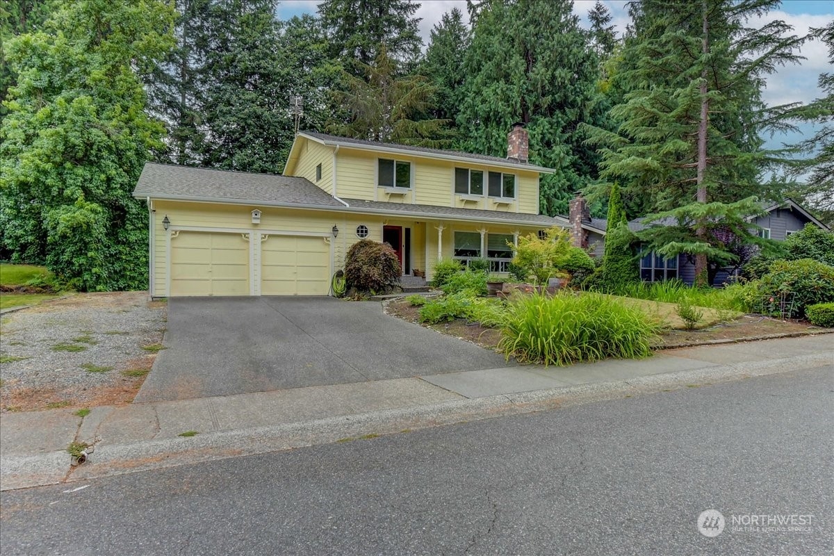10451 Northeast 204th Place Bothell, WA 98011 - Photo 1 of 40 a front view of a house with a yard and garage
