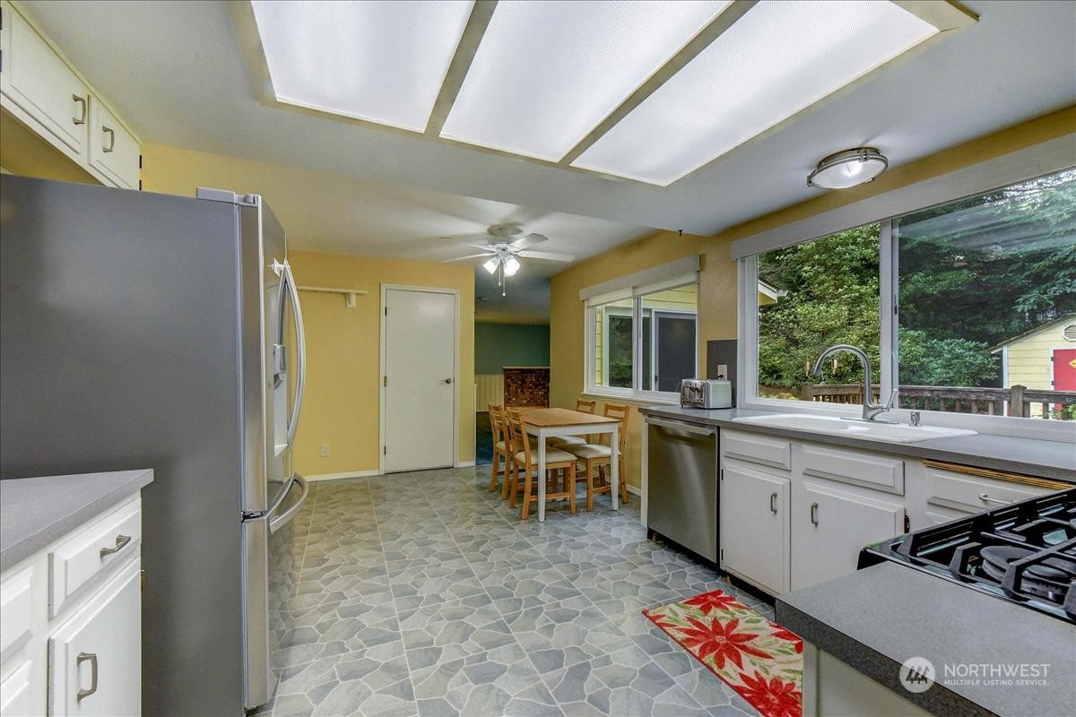 10451 Northeast 204th Place Bothell, WA 98011 - Photo 11 of 40 a large white kitchen with a large window
