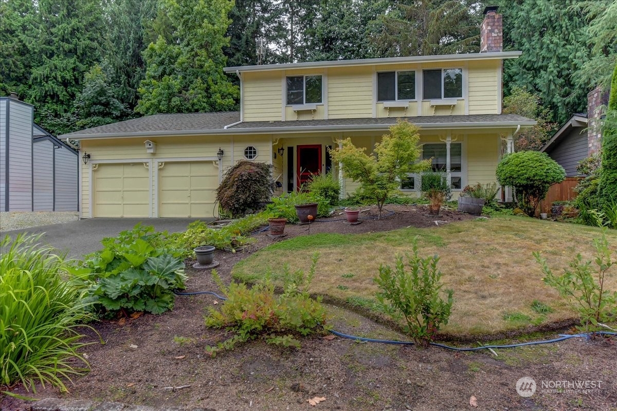 10451 Northeast 204th Place Bothell, WA 98011 - Photo 2 of 40 a front view of a house with garden and plants