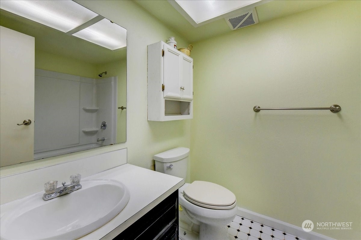 10451 Northeast 204th Place Bothell, WA 98011 - Photo 29 of 40 a bathroom with a sink and a mirror