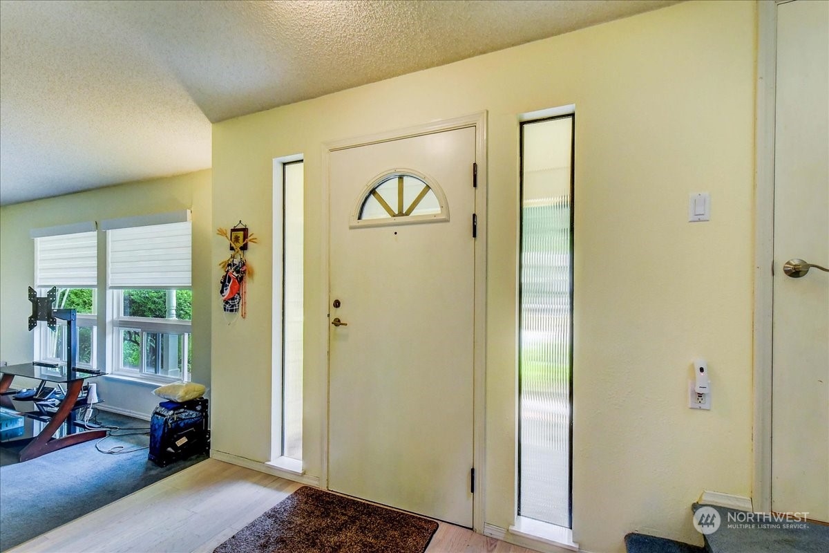 10451 Northeast 204th Place Bothell, WA 98011 - Photo 4 of 40 a view of a hallway with couch and dining area