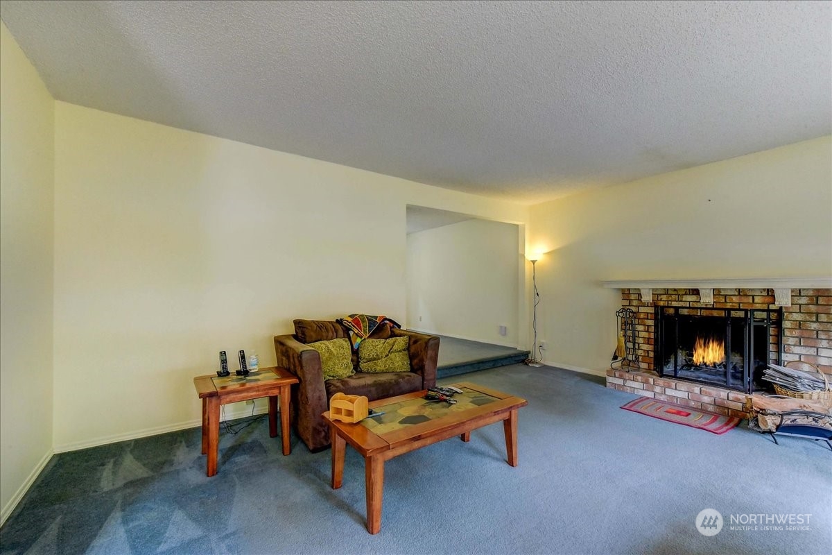 10451 Northeast 204th Place Bothell, WA 98011 - Photo 6 of 40 a living room with furniture and a fireplace