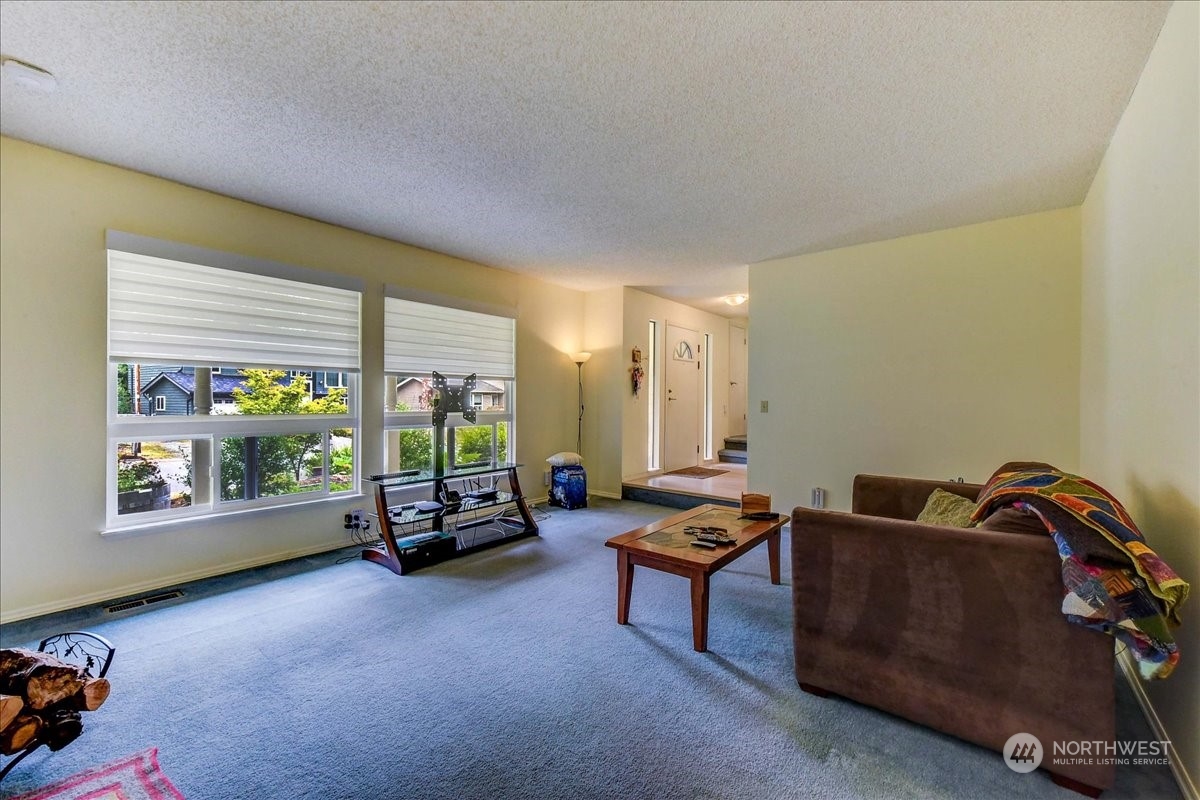 10451 Northeast 204th Place Bothell, WA 98011 - Photo 8 of 40 a living room with furniture and a window