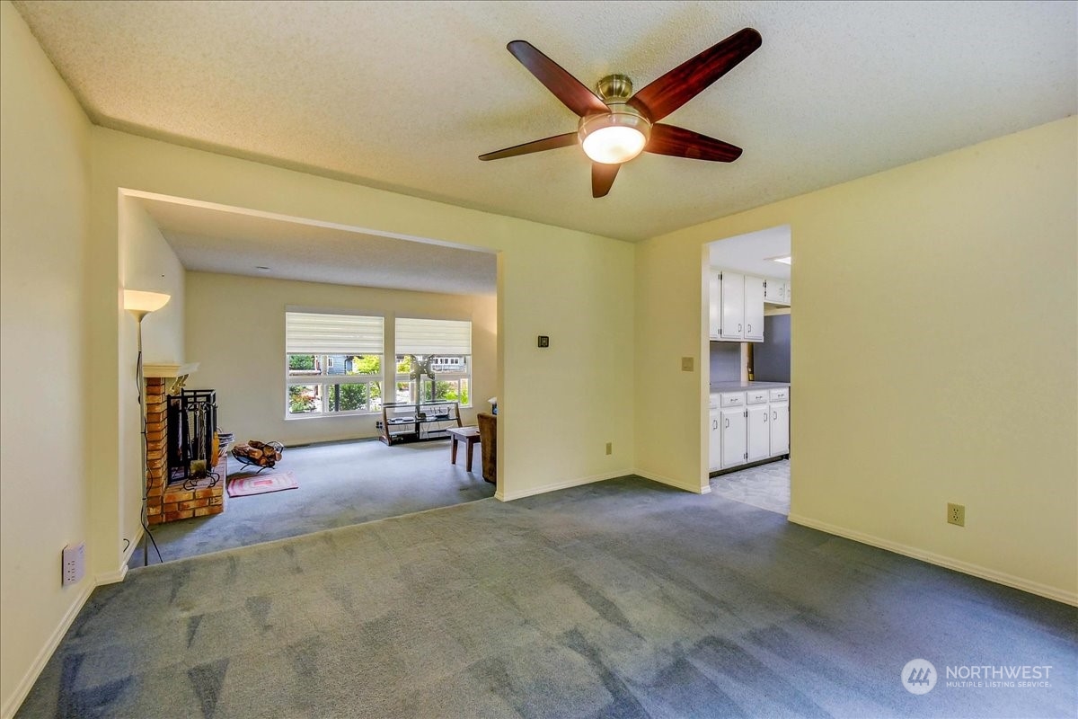 10451 Northeast 204th Place Bothell, WA 98011 - Photo 9 of 40 a view of a livingroom with workspace and a ceiling fan