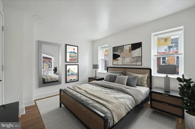 a bedroom with a large bed and a painting on the wall