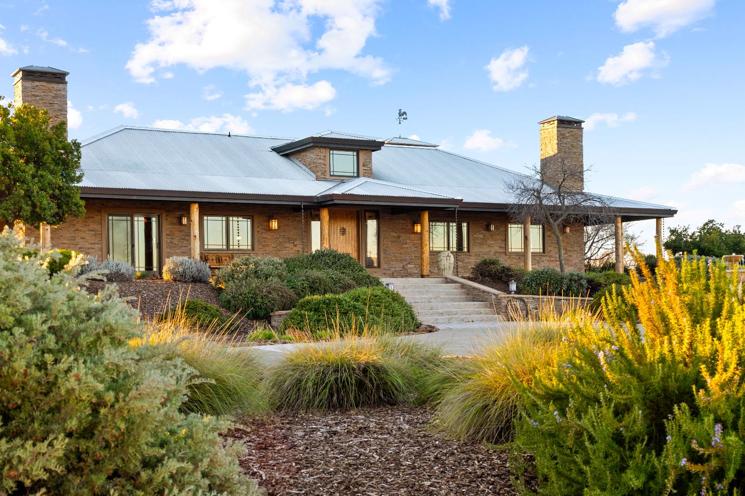5630 Grazing Hill Road Shingle Springs, CA 95682 - Photo 5 of 86 a front view of a house with a yard and fountain in middle