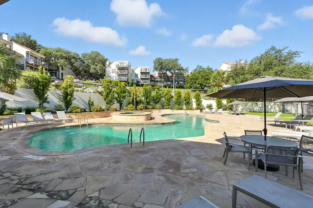 a view of a swimming pool with a garden and plants