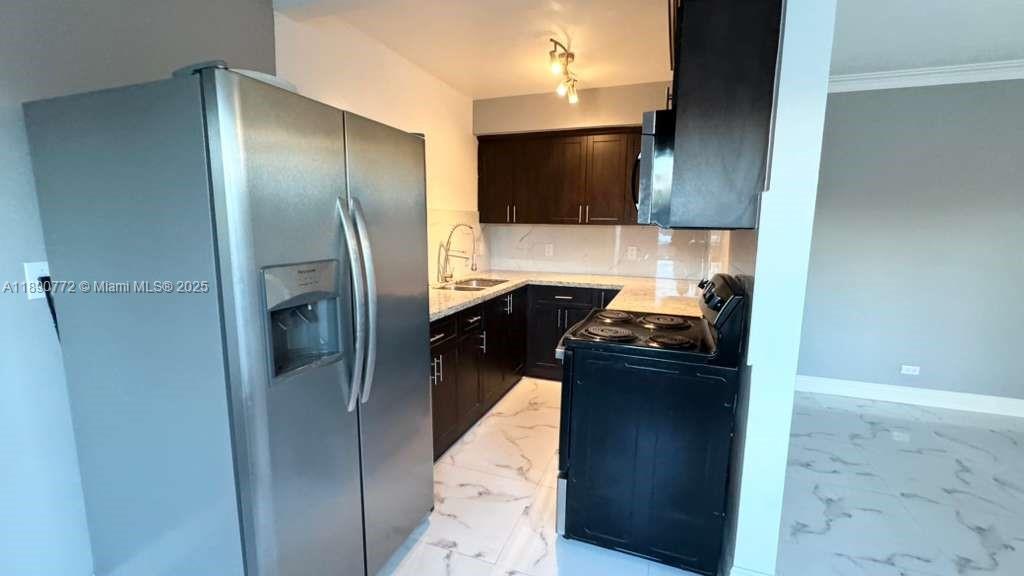a kitchen with a refrigerator and a stove
