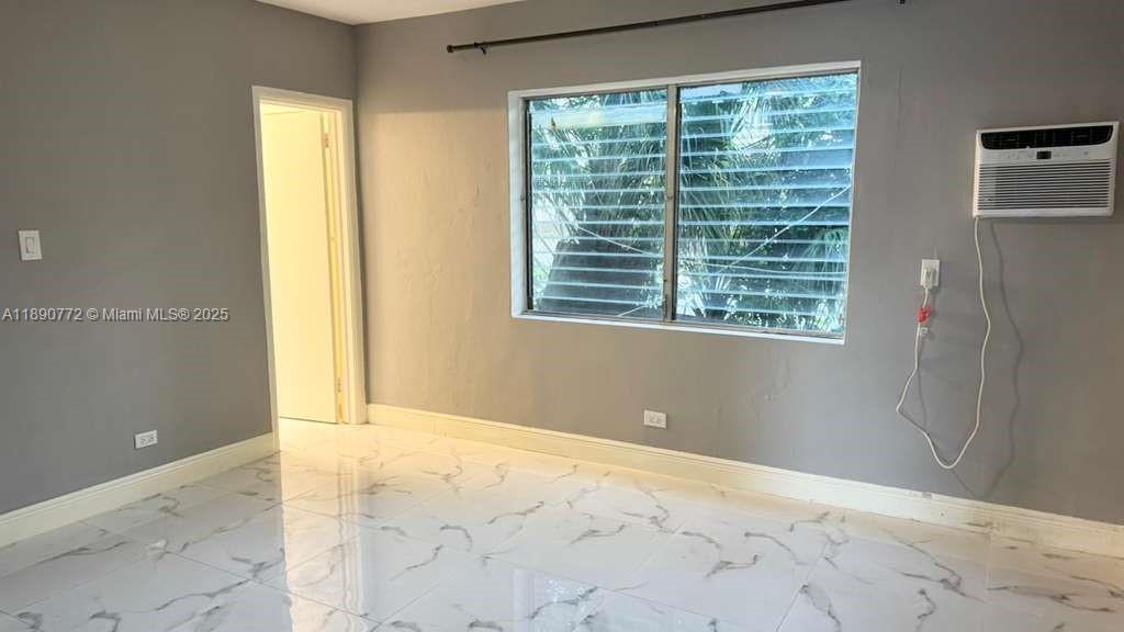 346 86th Street, Unit 2 Miami Beach, FL 33141 - Photo 6 of 13 a view of an empty room with a window