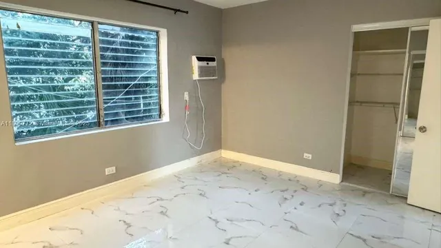 a view of an empty room with a window