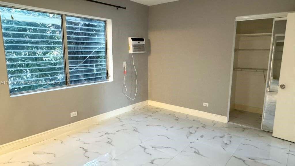 346 86th Street, Unit 2 Miami Beach, FL 33141 - Photo 9 of 13 a view of an empty room with a window