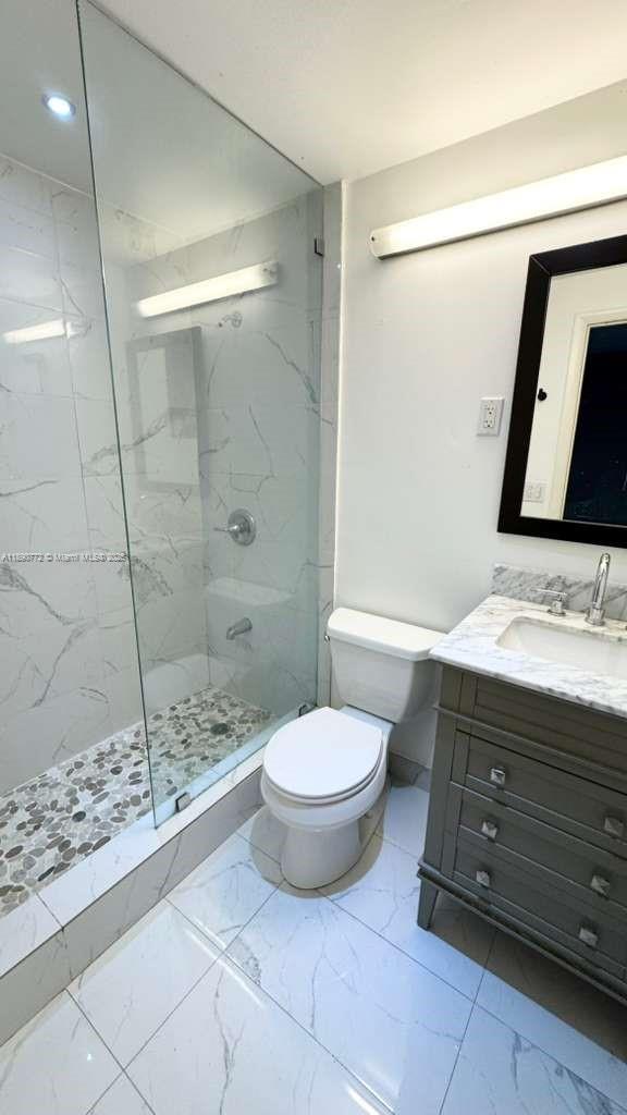 346 86th Street, Unit 2 Miami Beach, FL 33141 - Photo 10 of 13 a bathroom with a sink toilet and shower