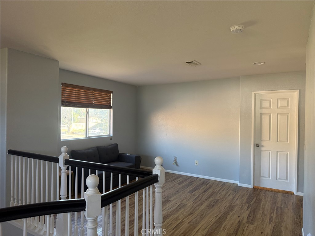 30456 Avenida Caylee Homeland, CA 92548 - Photo 17 of 27 a view of an empty room with wooden floor