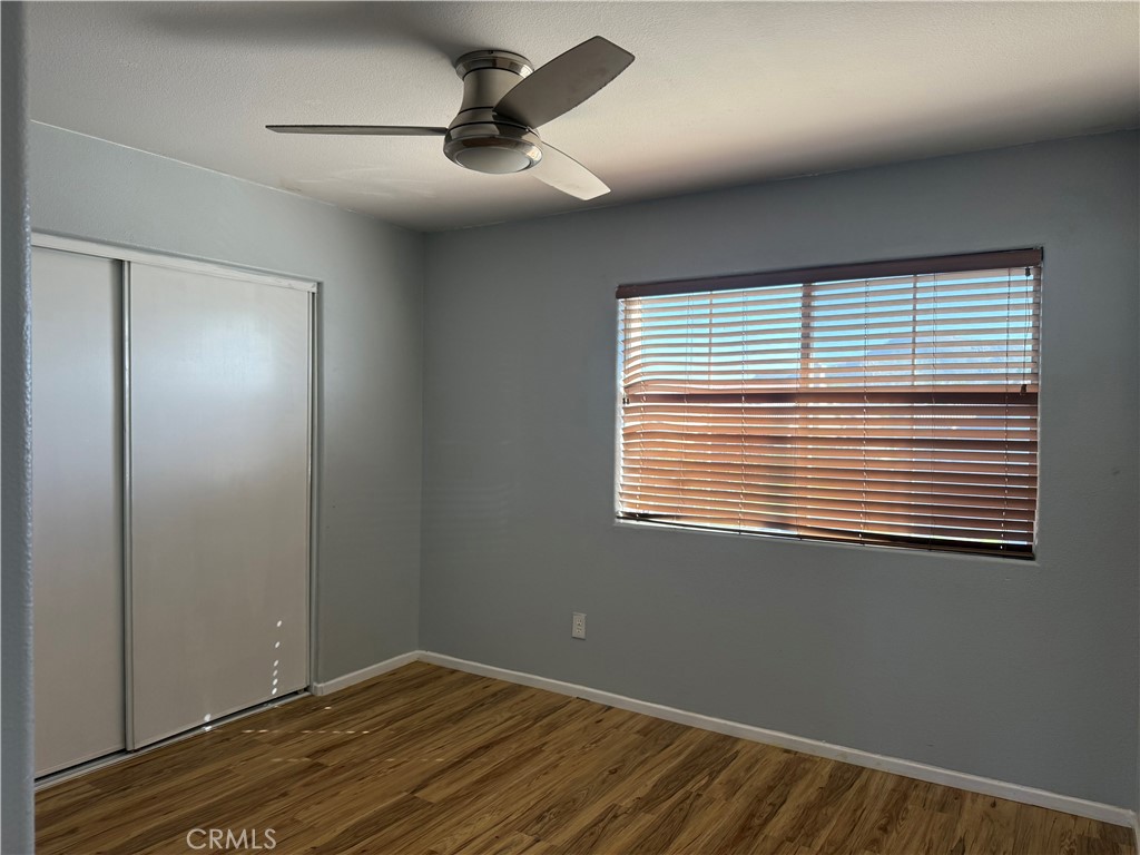 30456 Avenida Caylee Homeland, CA 92548 - Photo 22 of 27 a view of an empty room with wooden floor and a window