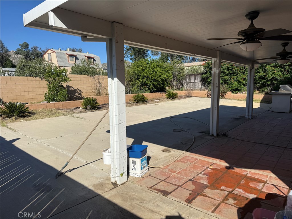 30456 Avenida Caylee Homeland, CA 92548 - Photo 26 of 27 a view of a patio with table and chairs under an umbrella with potted plants
