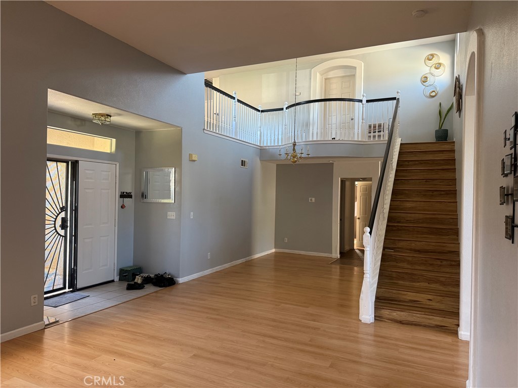 30456 Avenida Caylee Homeland, CA 92548 - Photo 5 of 27 an empty room with wooden floor and stairs
