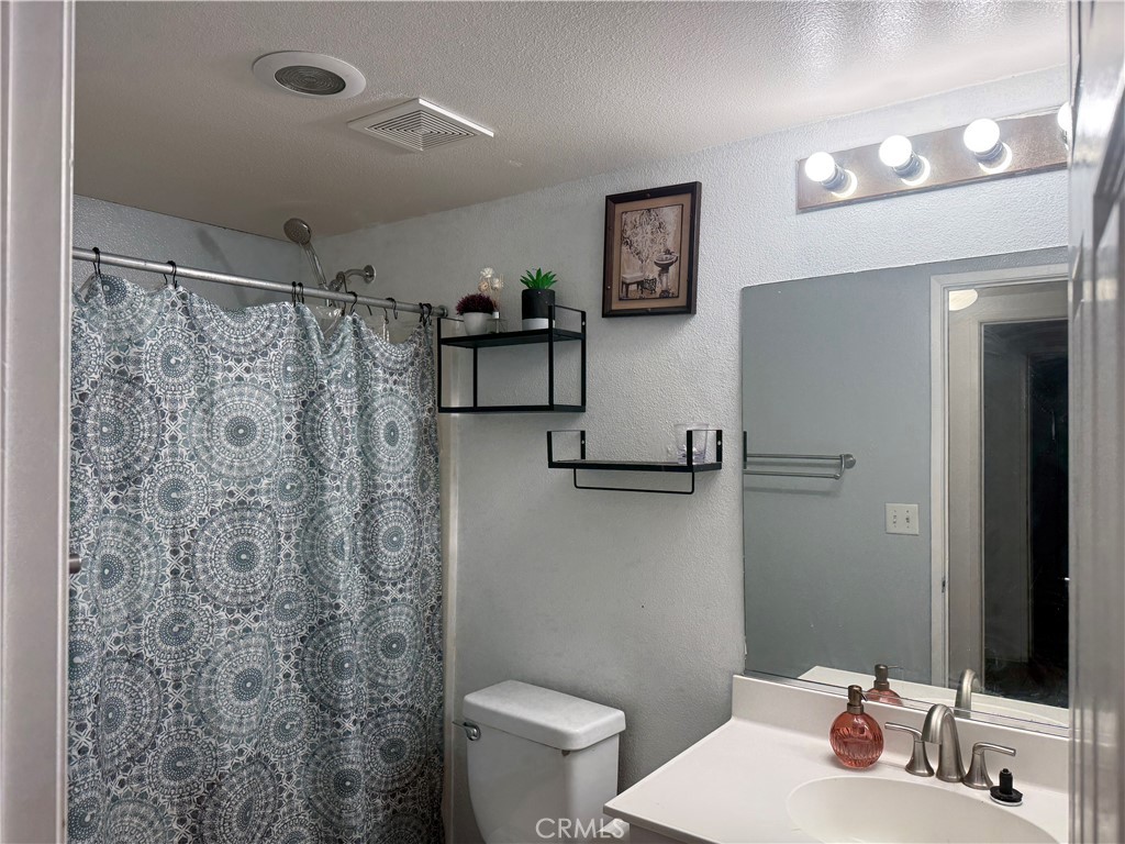 30456 Avenida Caylee Homeland, CA 92548 - Photo 7 of 27 a bathroom with a sink toilet and shower
