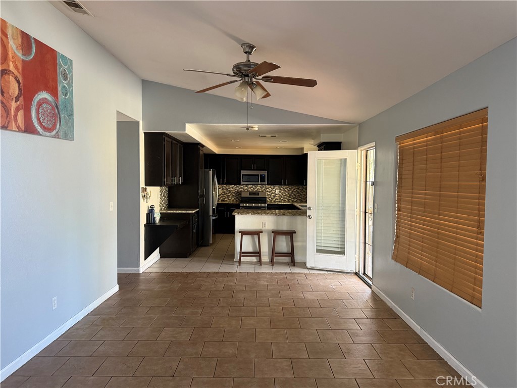 30456 Avenida Caylee Homeland, CA 92548 - Photo 9 of 27 a view of a kitchen with furniture and a ceiling fan