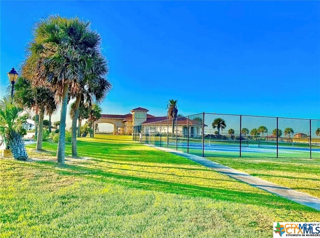 294 East Lago Loop Port O'Connor, TX 77982 - Photo 10 of 14 a view of a houses with a yard and palm trees