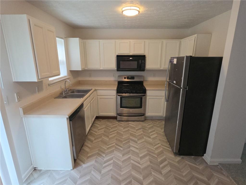 9432 Lakeview Road Union City, GA 30291 - Photo 2 of 11 a kitchen with a refrigerator sink and microwave