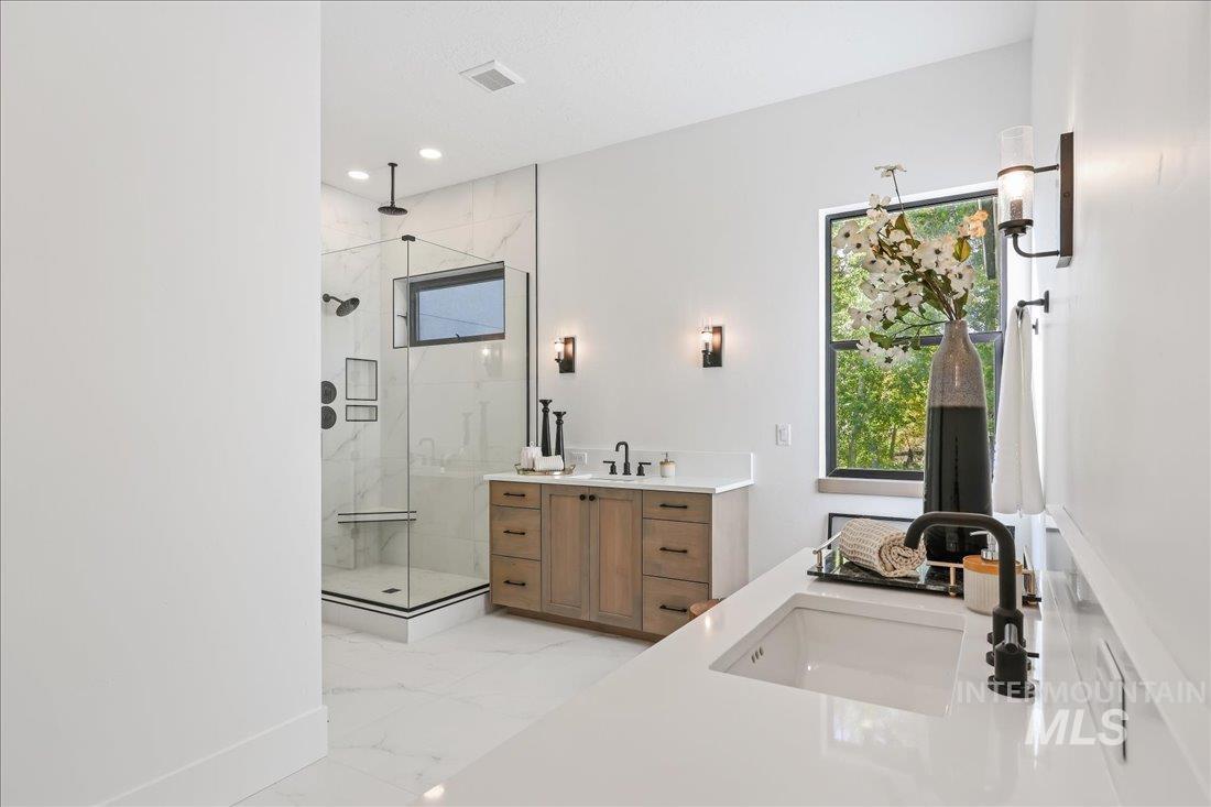 665 Watkins Street Middleton, ID 83644 - Photo 26 of 34 Full bathroom with two vanities, a marble finish shower, light marble finish floors, and recessed lighting