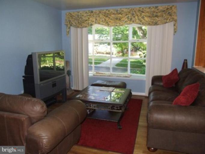 3719 Astoria Road Kensington, MD 20895 - Photo 11 of 19 a living room with furniture and a flat screen tv