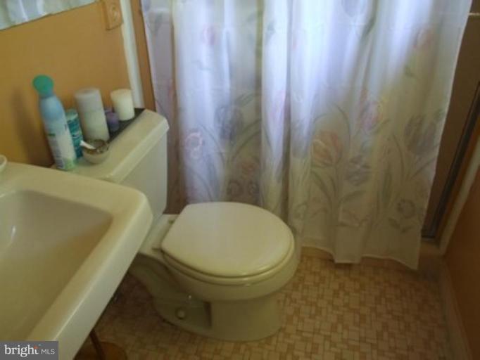 3719 Astoria Road Kensington, MD 20895 - Photo 14 of 19 a white toilet sitting next to a small sink